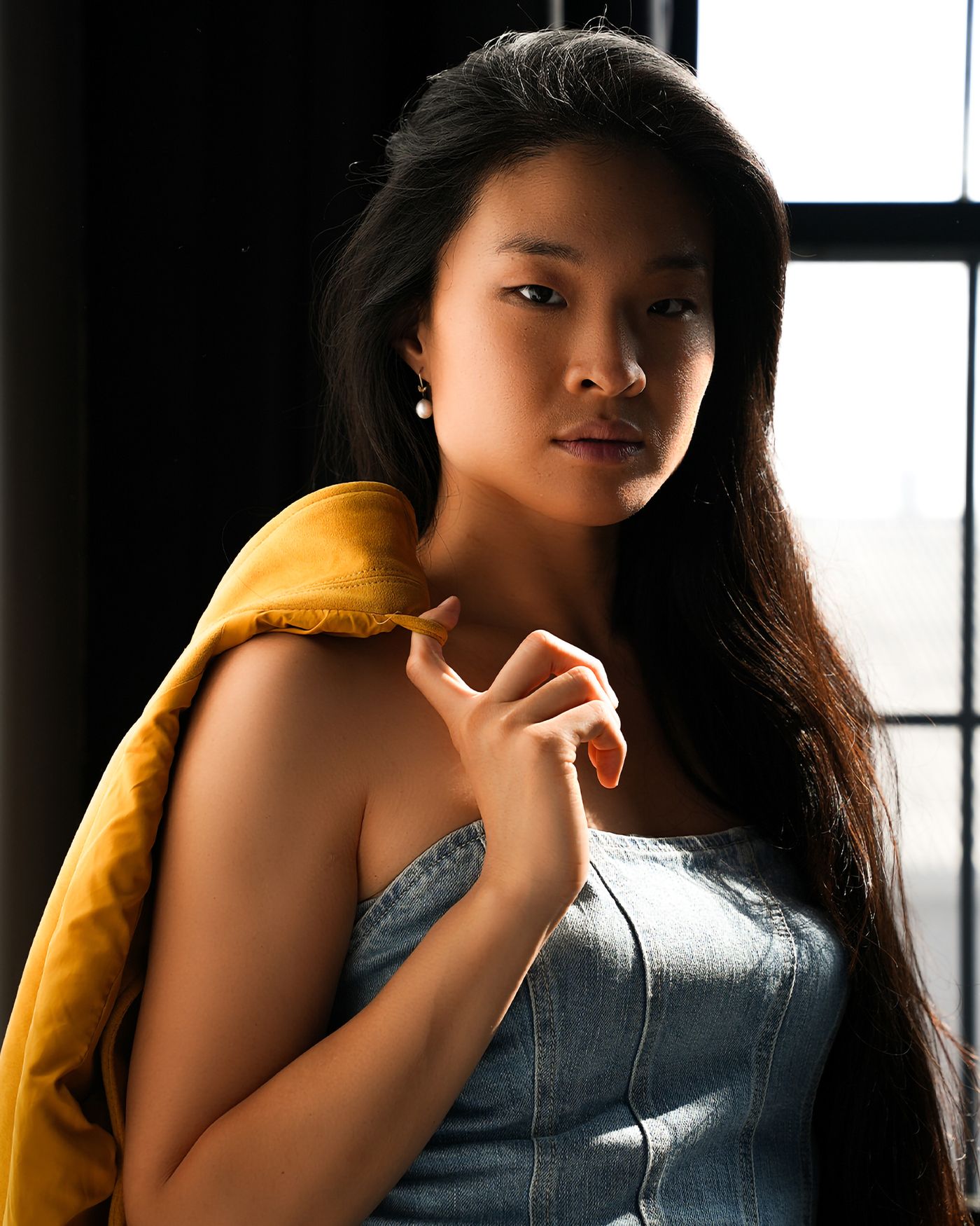 Woman beside a bright window