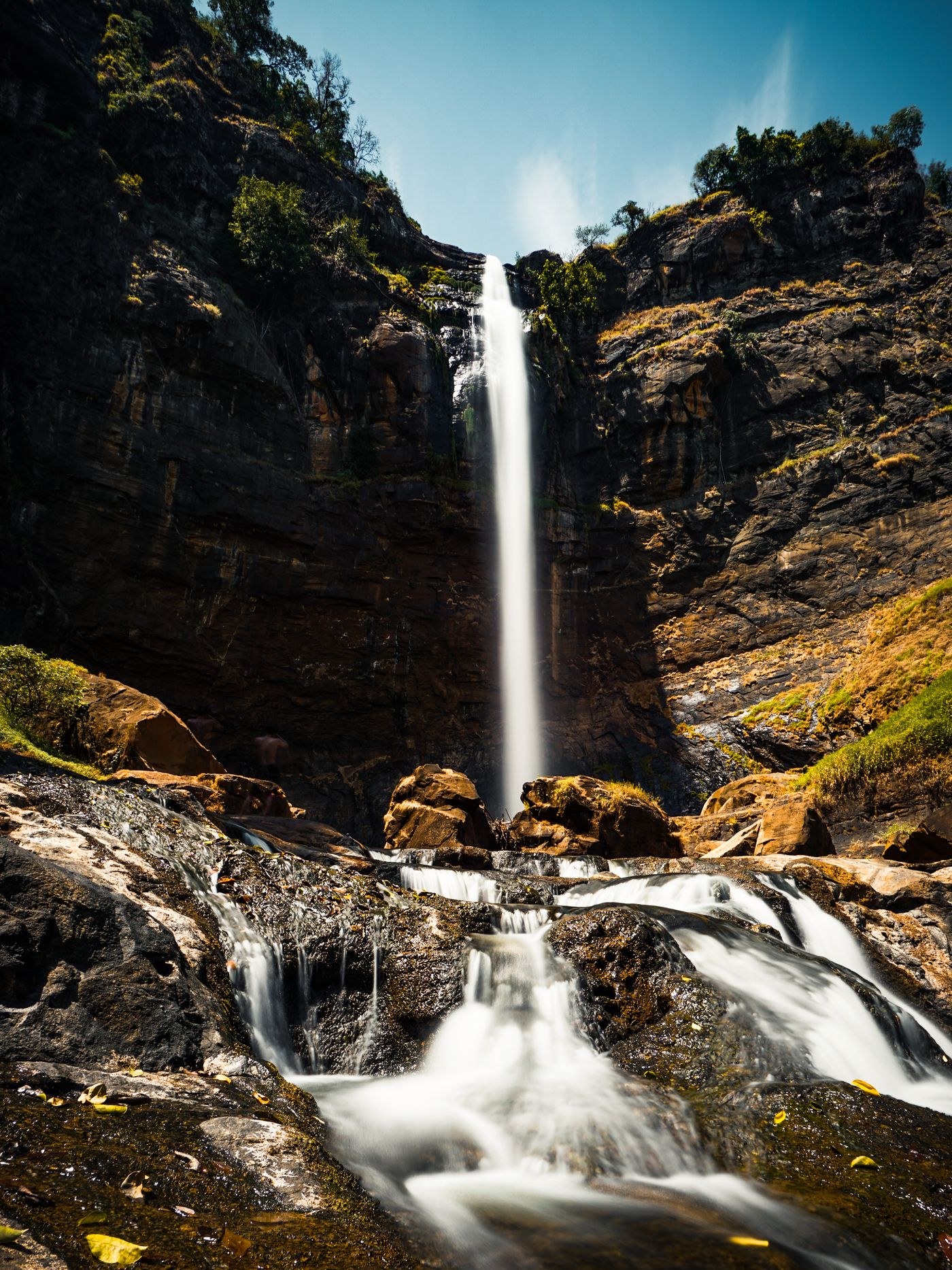 Waterfall flowing between dark rocks