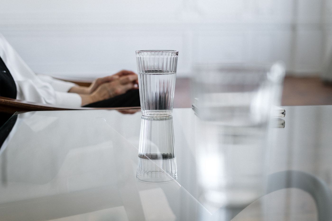 Glass of water and its reflection on a table