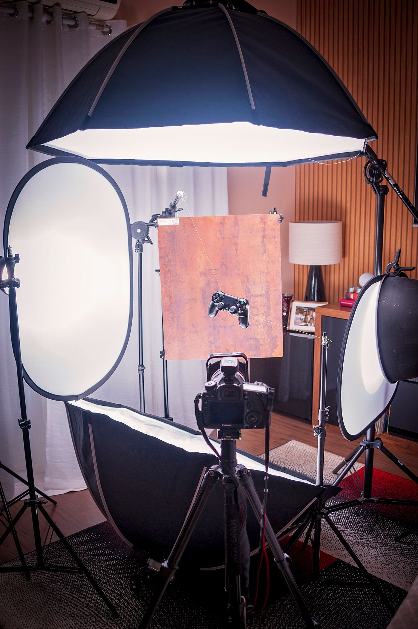 Camera surrounded by lighting and reflectors in a studio