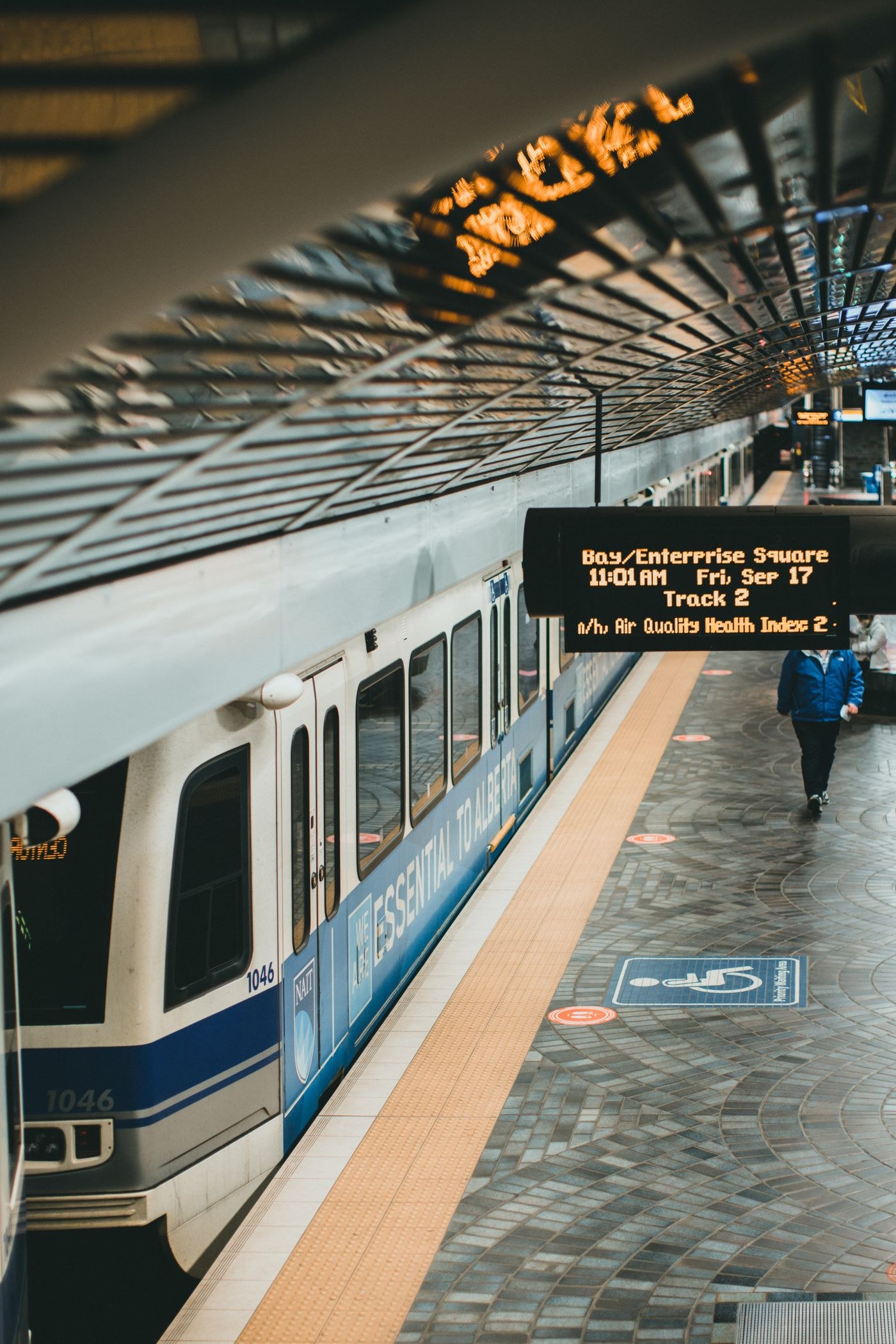 Train beside a covered railway platform
