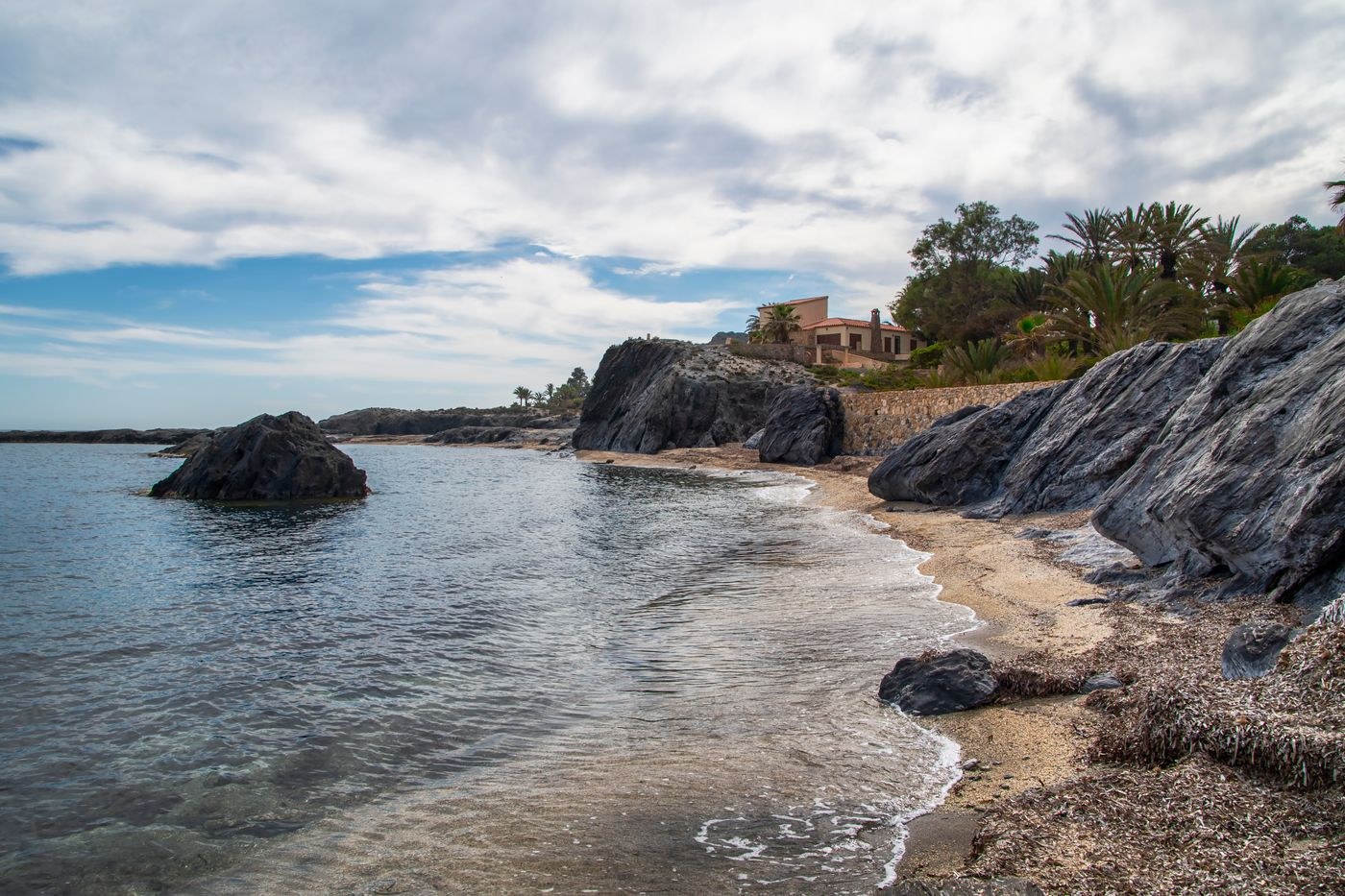 Rocky coastline beneath an overcast sky