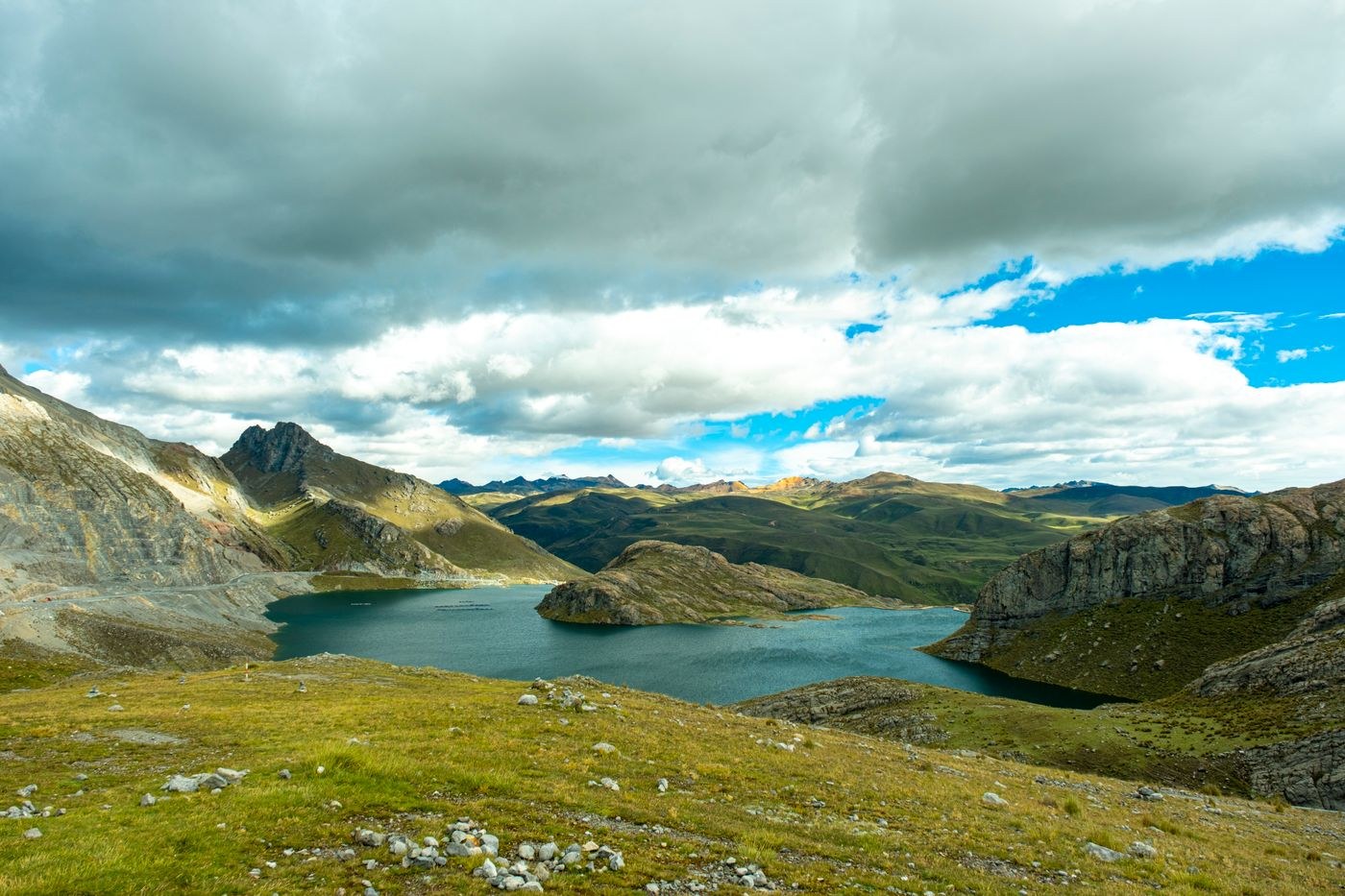 Mountain lake and ridges beneath changing clouds