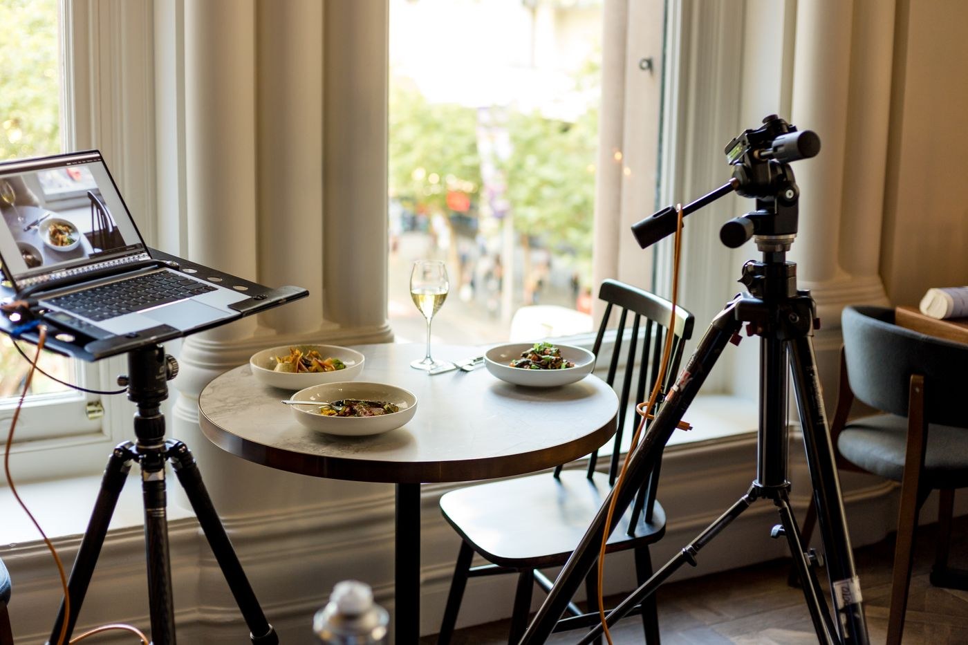 Camera and food setup beside a bright window