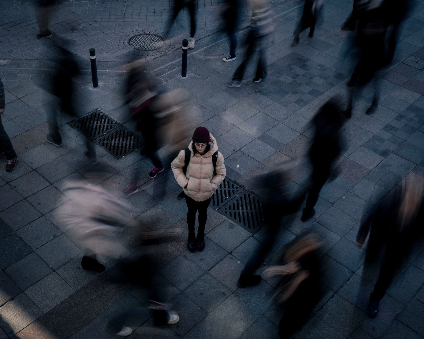 Still figure surrounded by blurred pedestrians