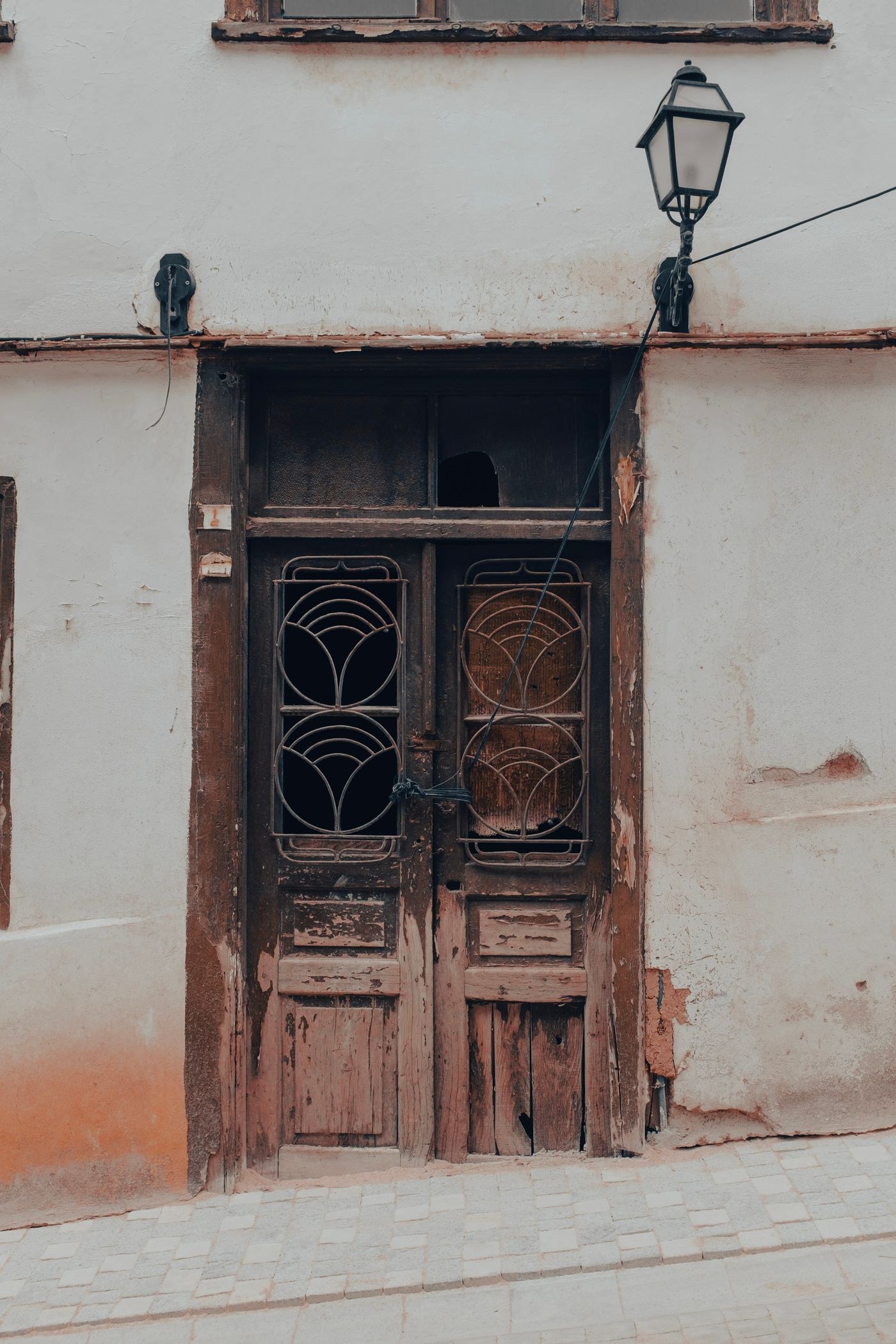 Weathered wooden doorway in a pale wall