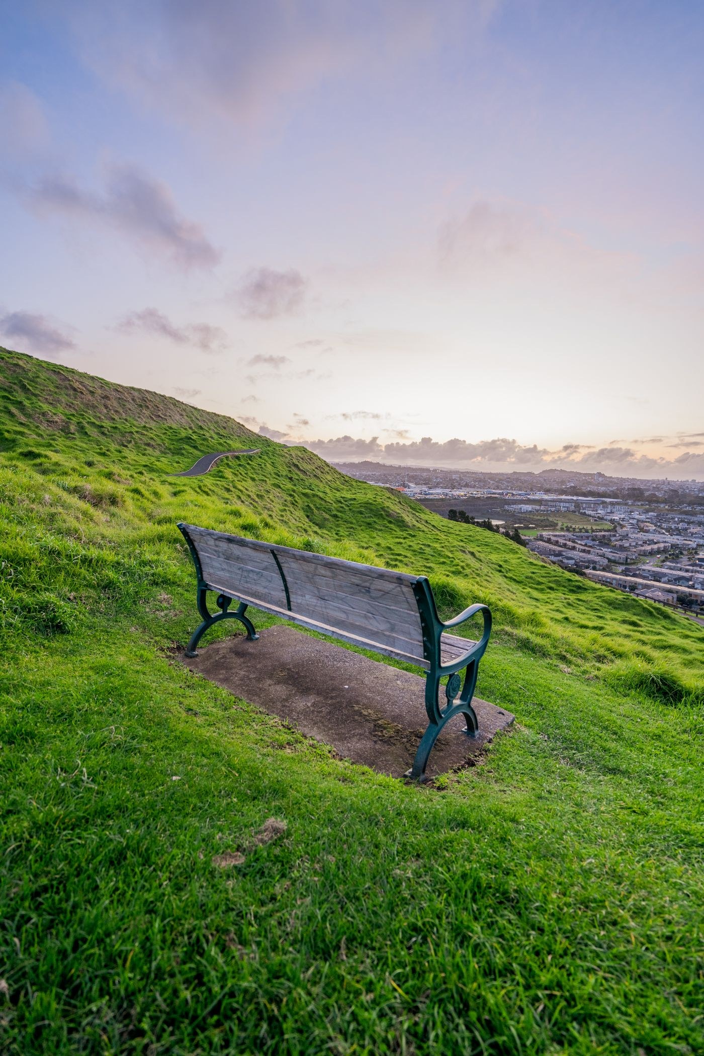 Small bench overlooking a broad green landscape