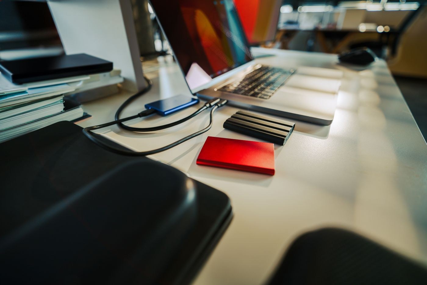 Several external drives on a computer desk